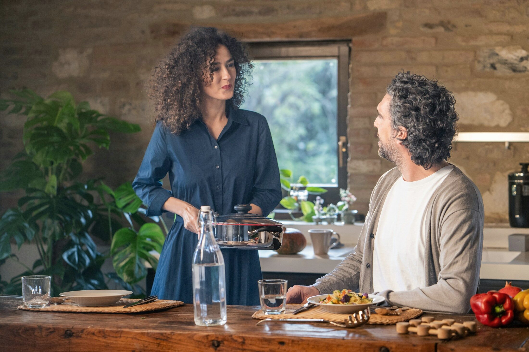 Two people cooking together in a home kitchen. Illustrative stock photograph, not an Almajour member or property