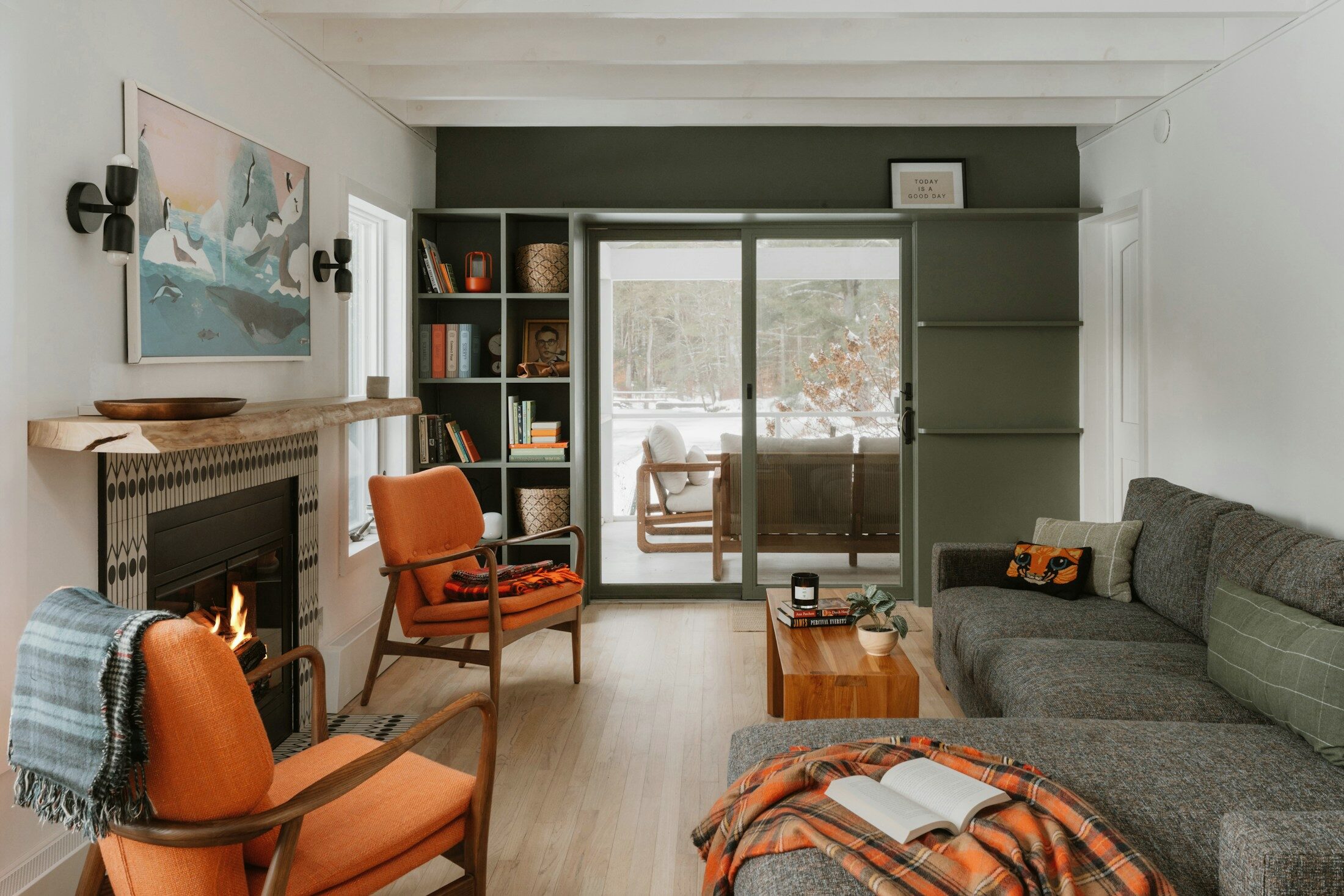 A living room with a fire lit and a book left open on a blanket. Illustrative stock photograph, not an Almajour property